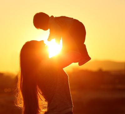 Mom and baby during sunset 